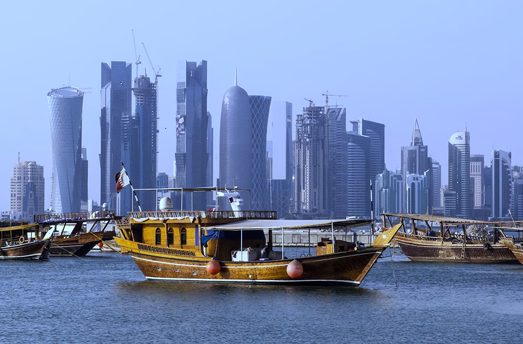 Traditional dhow boats on Doha Corniche with the West Bay skyline behind