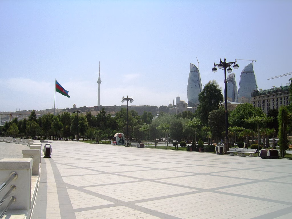 Baku Boulevard with Azerbaijan flag and Flame Towers in the distance